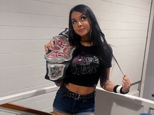 Cora Jade as AJ Lee
